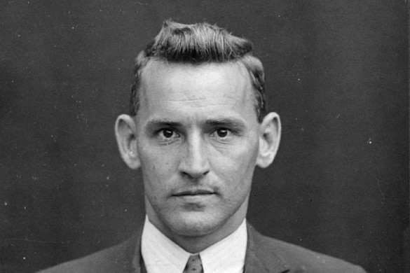 Black and white photo of man looking into camera