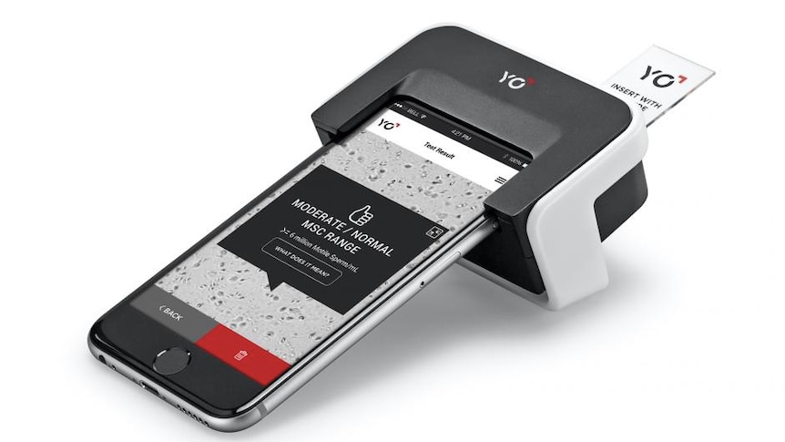 The YO at-home sperm testing kit is clipped on to a smartphone.