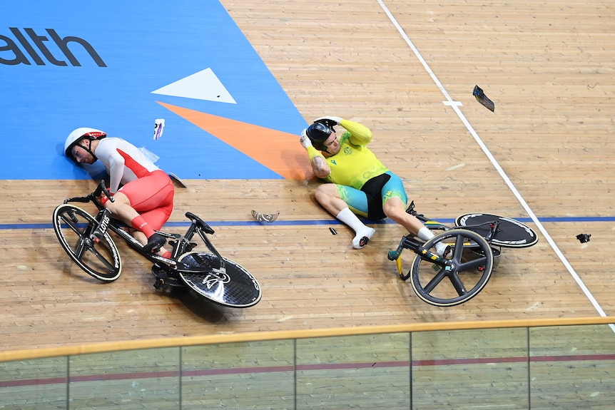 Two cyclists down on the banked cycling track, one is Englishman Joe Truman and the other Australia's Matthew Glaetzman.
