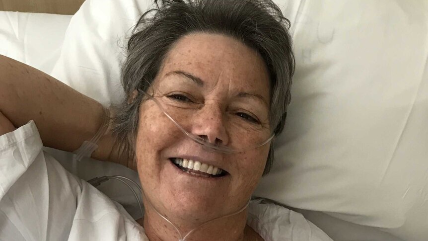 Maureen Santamaria recovers in a hospital bed