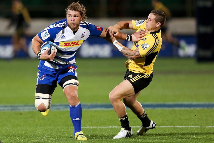 Fend off ... the Stormers' Duane Vermeulen holds off the Hurricanes' TJ Perenara.