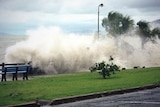 A storm surge hits Airlie Beach in north Queensland.