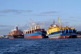 A number of cargo ships sit at dock at Fremantle Port.