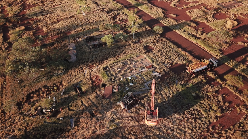 Aerial shot of demolition crews working at the former Wittenoom town site.