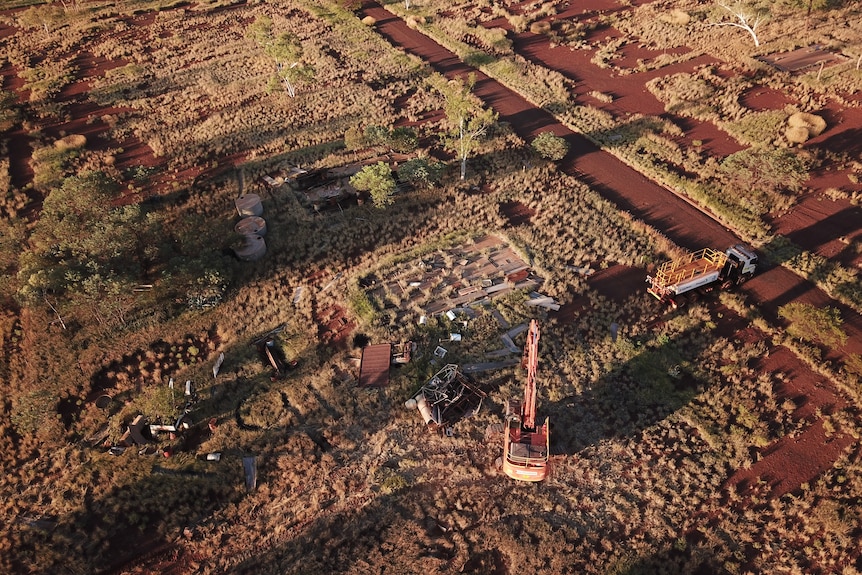 Aerial shot of demolition crews working at the former Wittenoom town site.