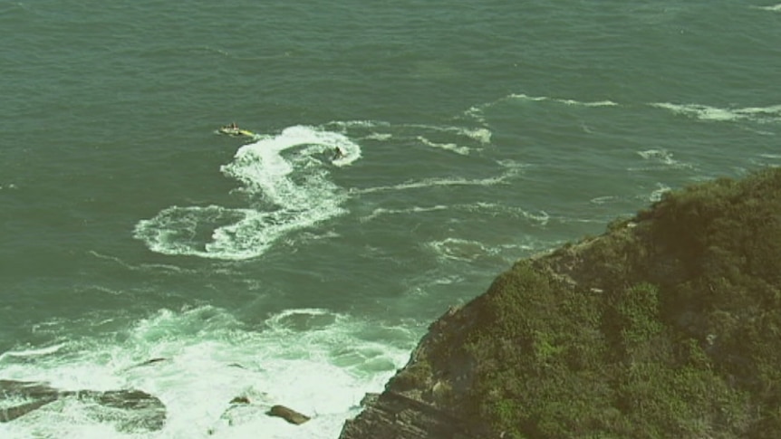 Lifeguards on jetskis search for a possible missing swimmer of the coast of Warriewood.