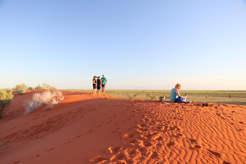 Tourists and locals enjoy the red sand dunes in Windorah