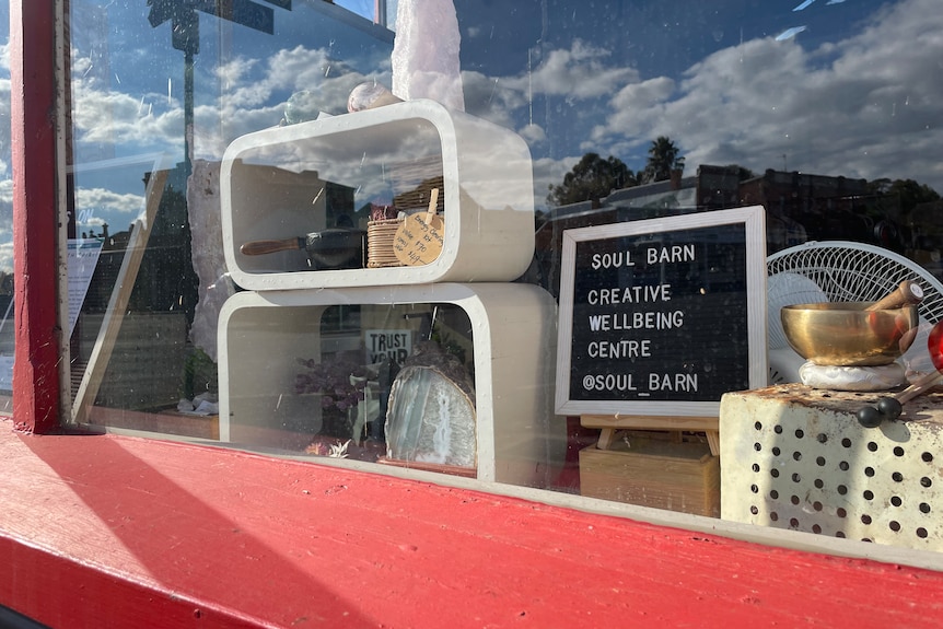Signs advertise 'Soul Barn' in a shopfront window.