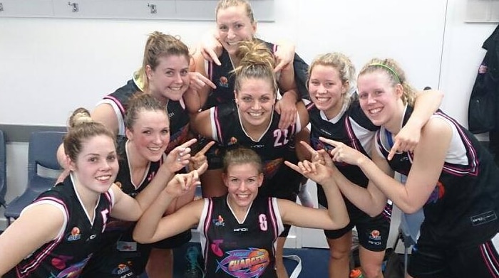 Female players from Hobart Chargers basketball team celebrate.