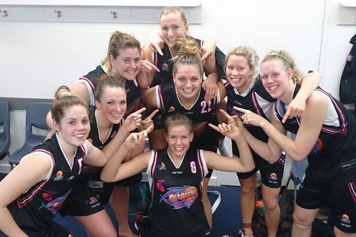 Female players from Hobart Chargers basketball team celebrate.