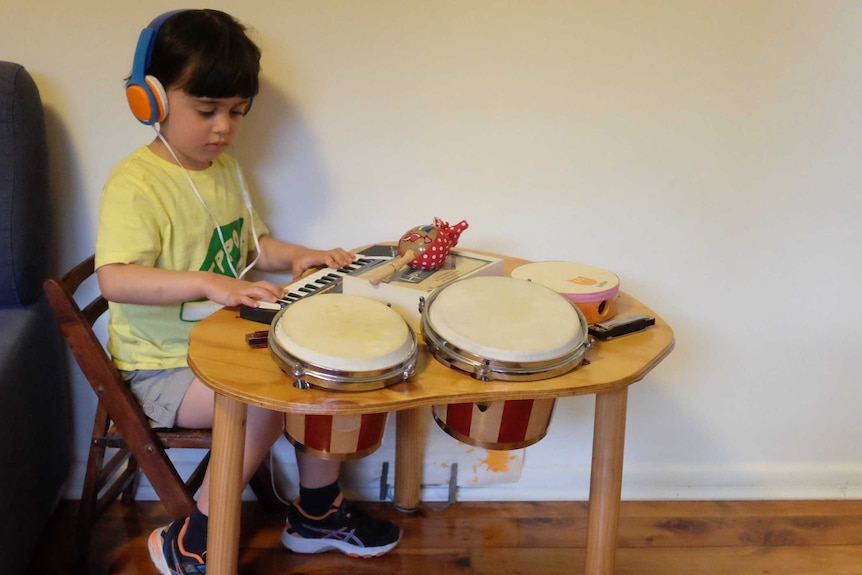 Four-year-old Miriam Zulfacar plays with her instruments