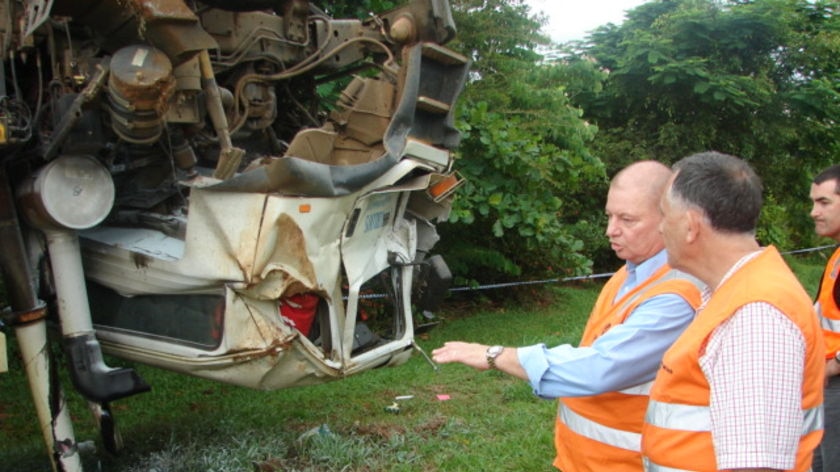 Local Qld MP Warren Pitt and Transport Minister John Mickel inspect the truck wreck.