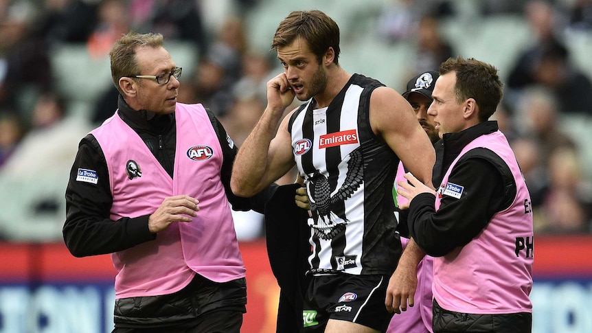 Collingwood's Alan Toovey comes off the ground with concussion against Western Bulldogs