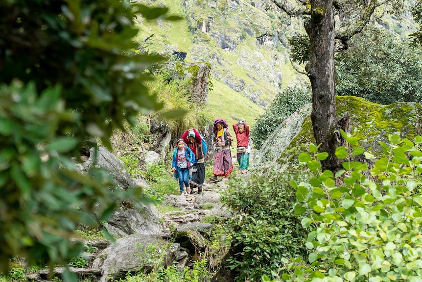 Devi walks at the head of a line.