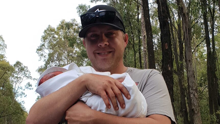 Dad Jarrad Earl stands proud as punch holding his new daughter Ivy.