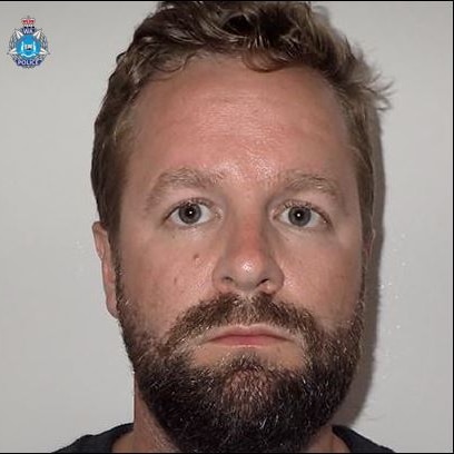 A head shot of a white man with a beard. Not smiling. A WA police logo is in the corner.