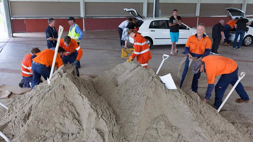 Workers and residents filling sandbags