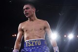 Boxer Tim Tszyu turns his bac as opponent Tony Harrison is waved off by the referee in their fight.