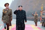 Kim Jong-un walks past North Korean soldiers as part of an inspection.