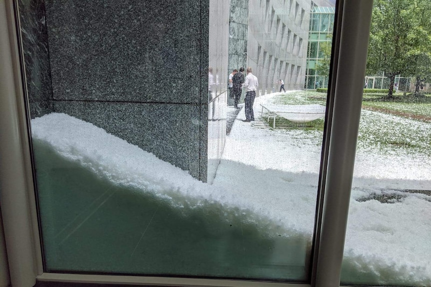 Hail stacked up outside a large glass window