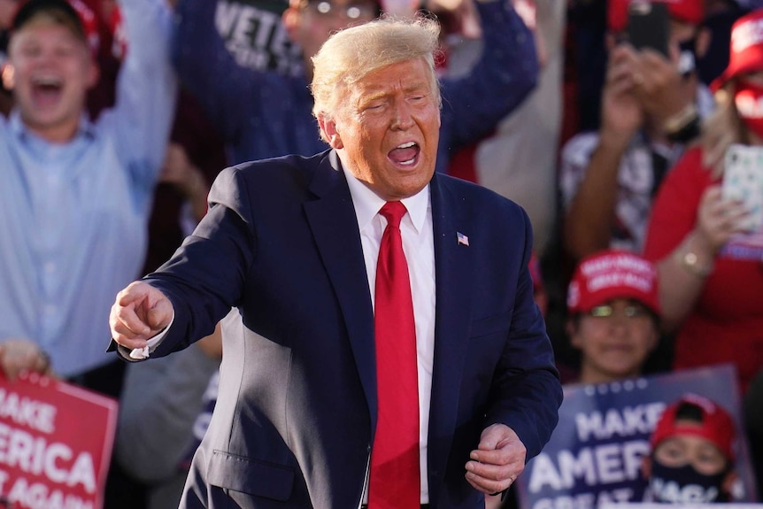 President Donald Trump works the crowd after speaking at a campaign rally