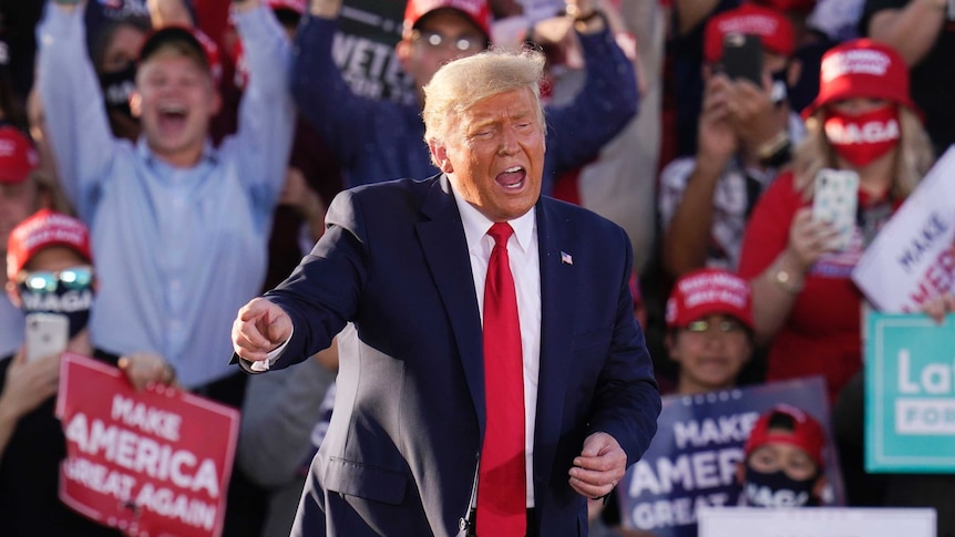 President Donald Trump works the crowd after speaking at a campaign rally