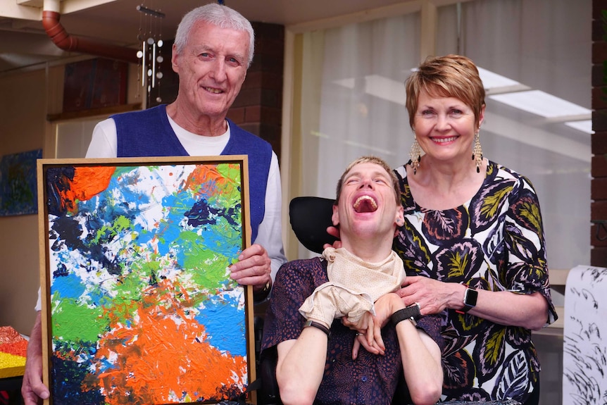 Oliver Mills with his mother Kerri and father Maurice, who is holding one of Oliver's creations.