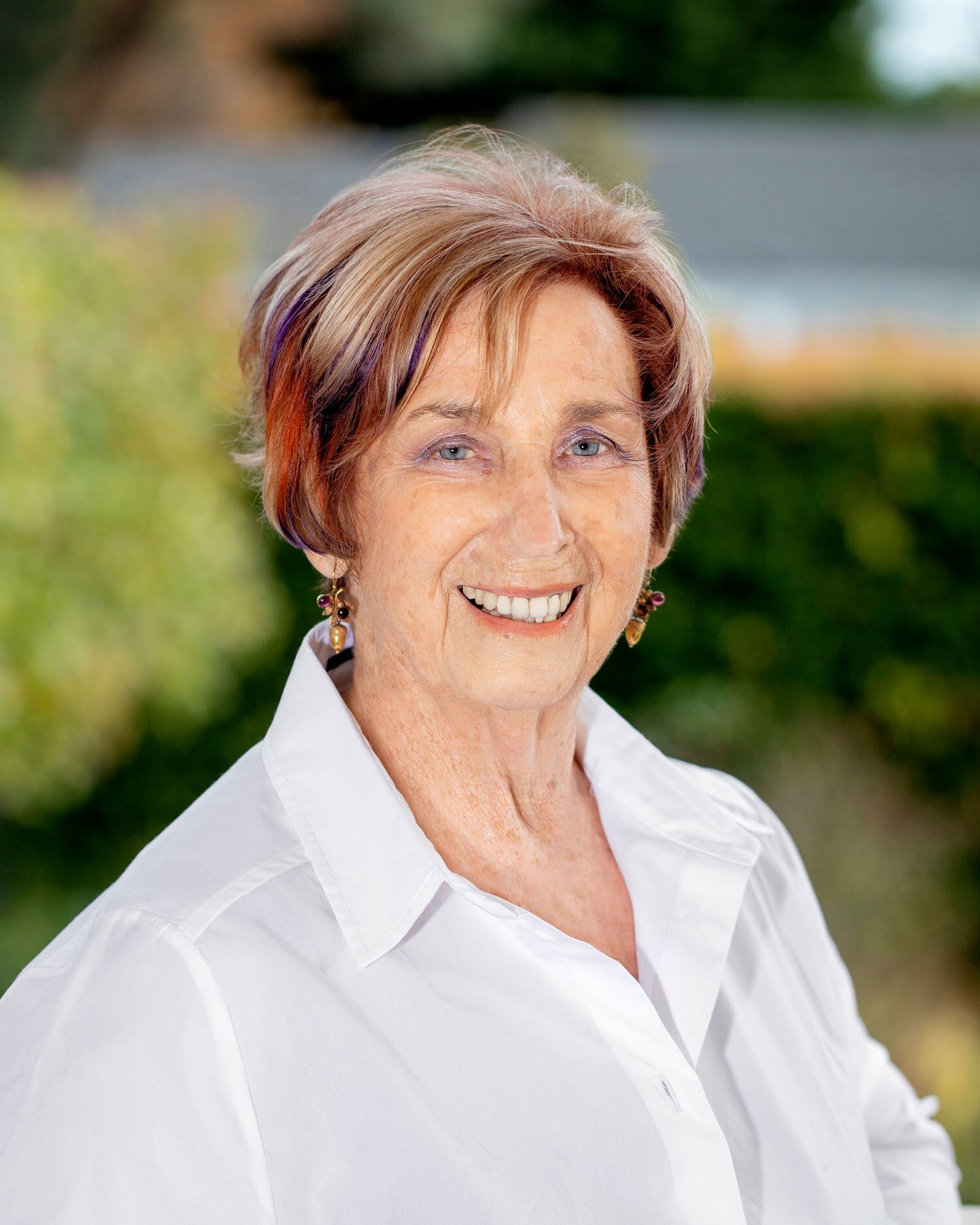 a woman in a white shirt smiling