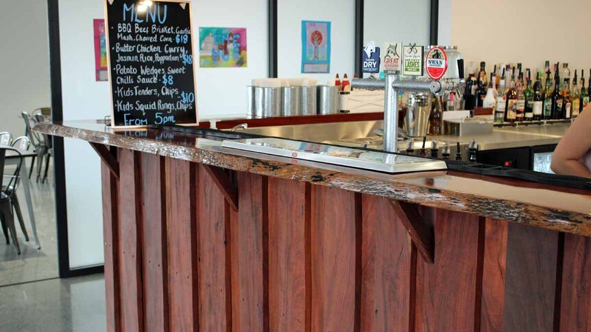 A timber bar top inside a building.