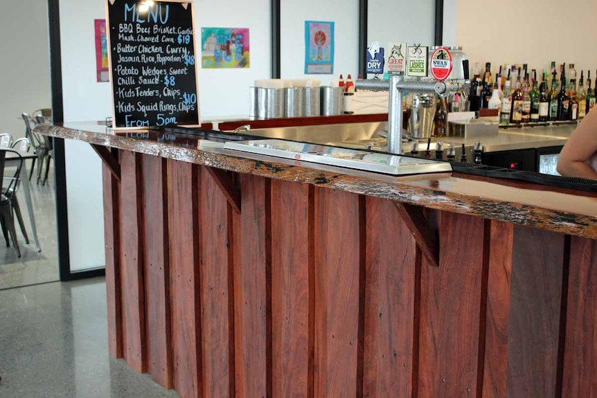 A timber bar top inside a building.