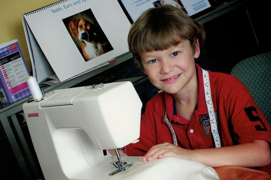 Connor O'Grady, when he was eight, sewing on a sewing machine.