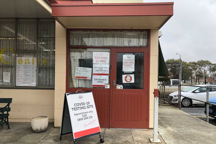 a building with signs about covid testing