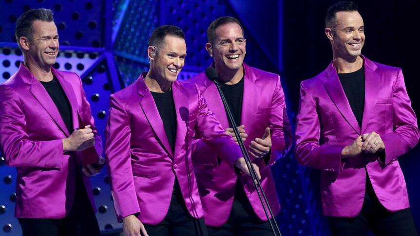 Human Nature in pink suit jackets on stage
