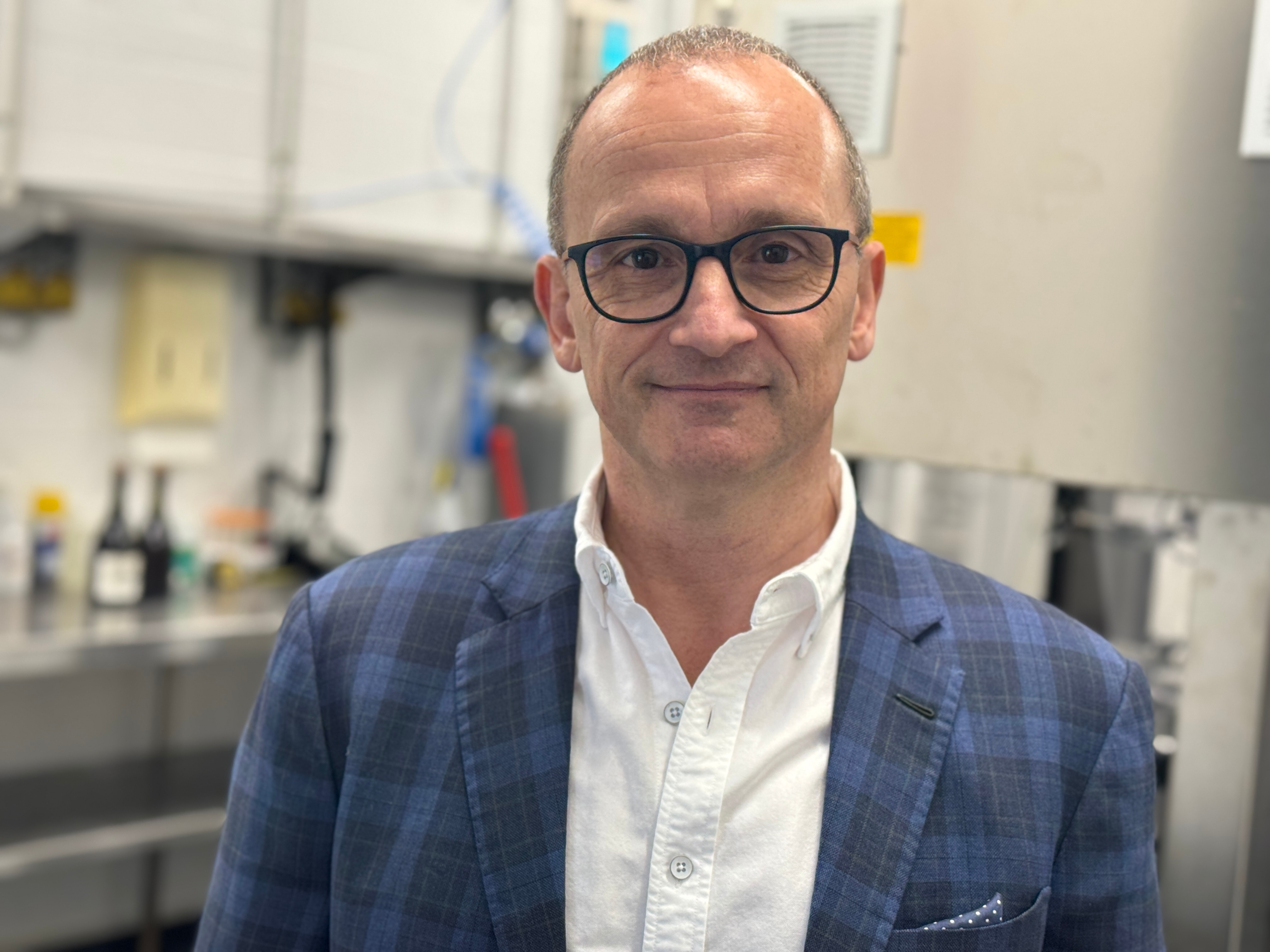 A man in glasses and a suit.