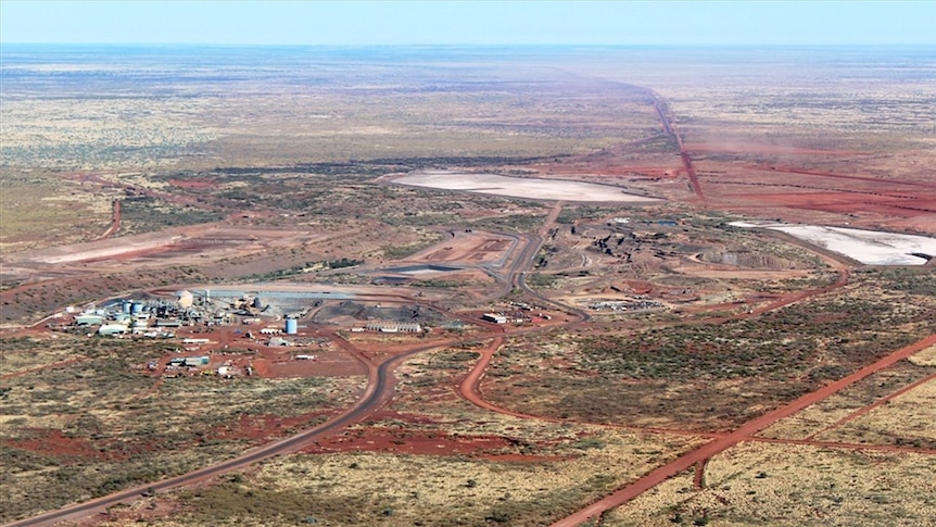An aerial shot of the gold mine, surrounded by red dirt