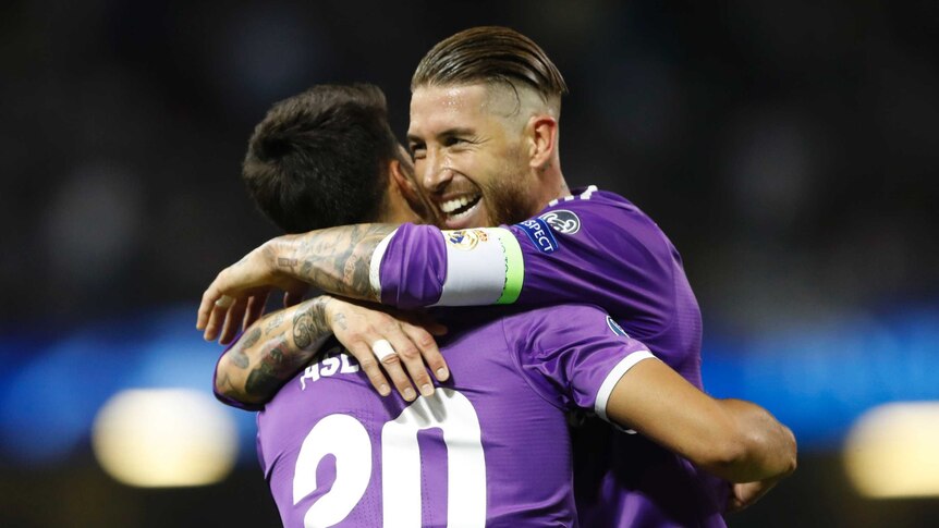Marco Asensio (L) is congratulated by Sergio Ramos after scoring Real Madrid's fourth goal against Juvetnus.