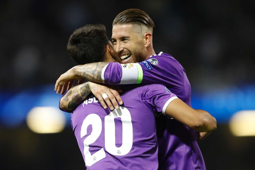 Marco Asensio (L) is congratulated by Sergio Ramos after scoring Real Madrid's fourth goal against Juvetnus.