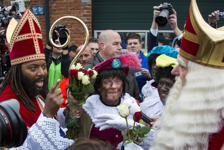 A black actor, Patrick Mathurin, confronts the white St. Nicolas during the official welcome in Maassluis, Netherlands.