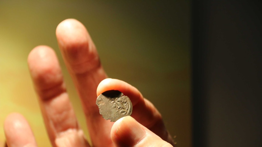 A Kilwa coin held by historian Mike Owens in Darwin.