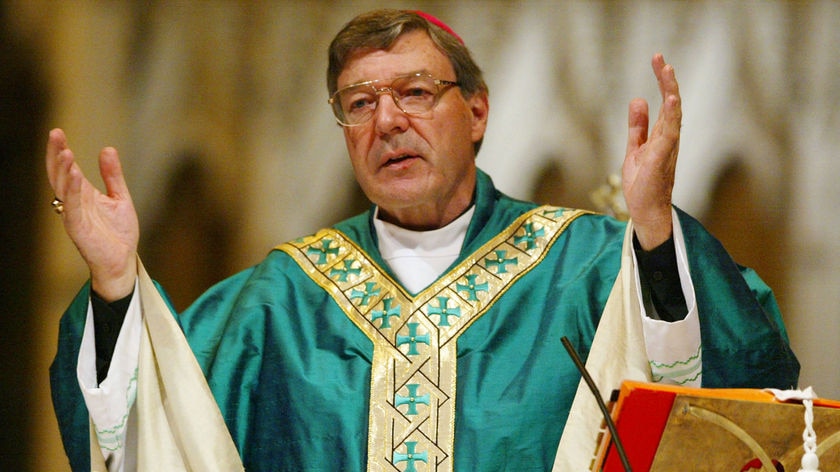 George Pell in church robes with his hands extended.