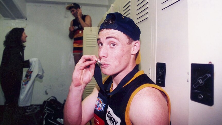 Simon Goodwin kisses his premiership medal.