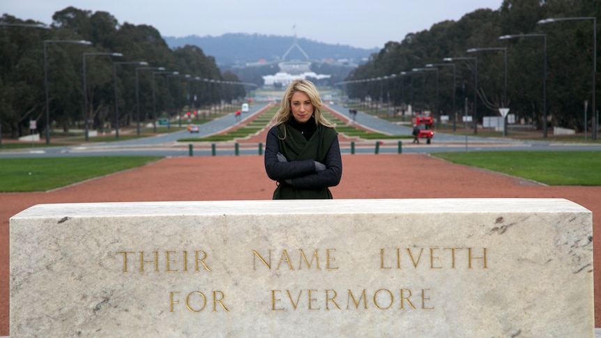 Woman stands in front of Australian War Memorial