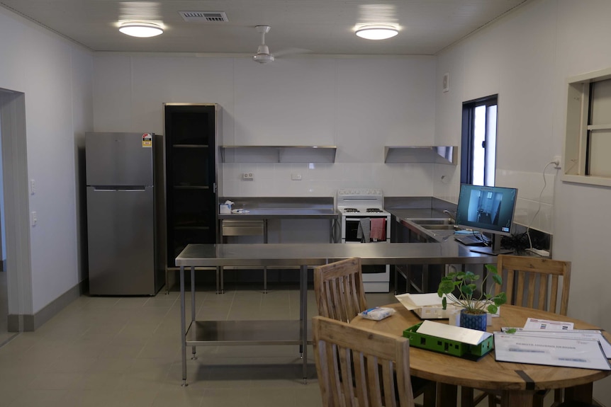 An interior of a building with a kitchen space.