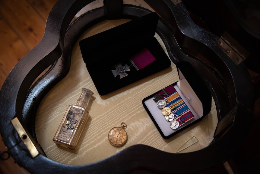 War medals and memorabilia are laid out on a table.