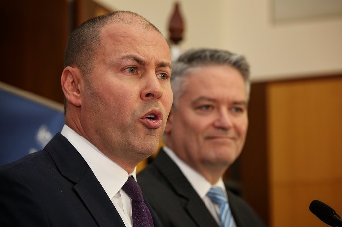 Josh Frydenberg delivers the federal budget on April 2, 2019 while Mathias Corman stands next to him.