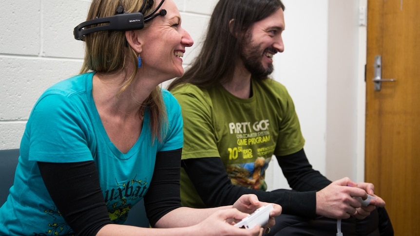 Emotions in video gaming is being tested by Ben Geelan (left), Dr Ian Lewis, and Dr Kristy de Salas (right).