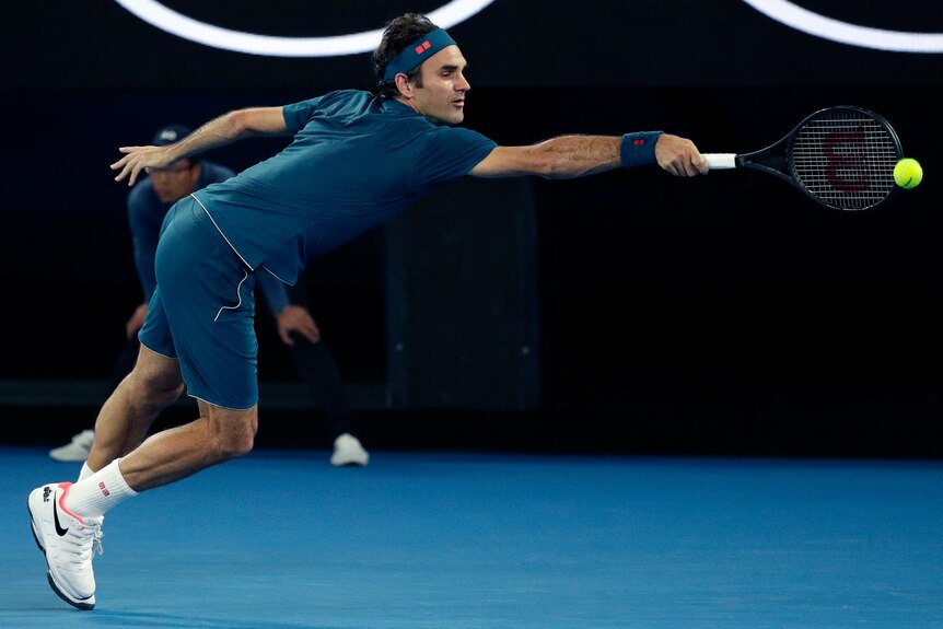 Roger Federer stretches for a backhand at the Australian Open