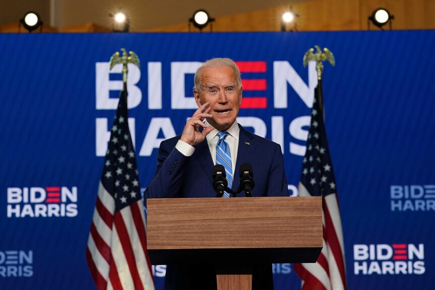 Joe Biden stands at a lectern
