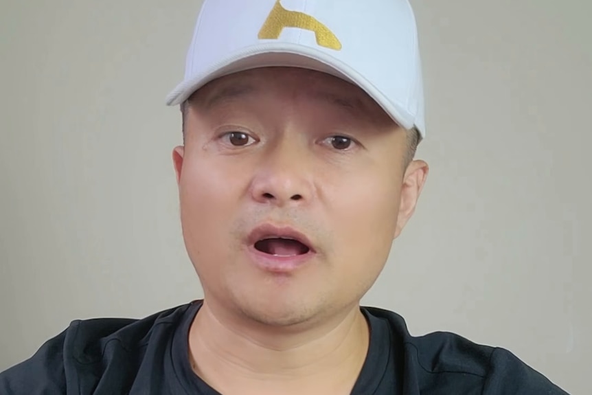 a chinese man in a white hat talking to the camera