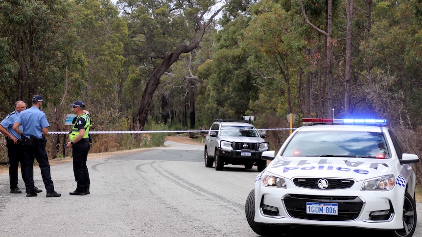 A police road block in bushland.